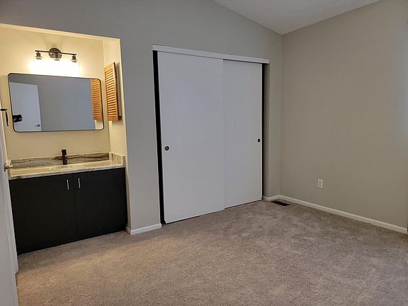 Alternate view of master bedroom with sink and vanity