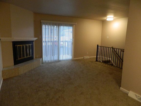 Living room, new carpet, walk out to deck, wood burning fireplace.