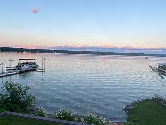 Reflections of a setting sun casts pink hues on the lake.