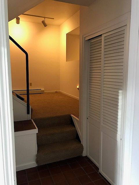 Closet to the right and steps up to the den