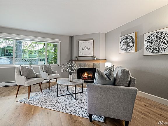 Large living room with wood burning fireplace and south facing windows to let the light in. Freshly painted walls and newer flooring to enjoy!