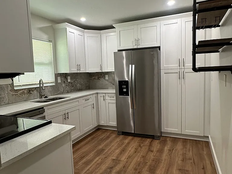 quartz countertops, newish stainless steel appliances, double sink, plenty of cabinet space