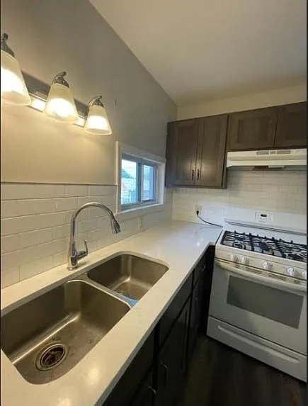 Kitchen with solid surface countertop and backsplash