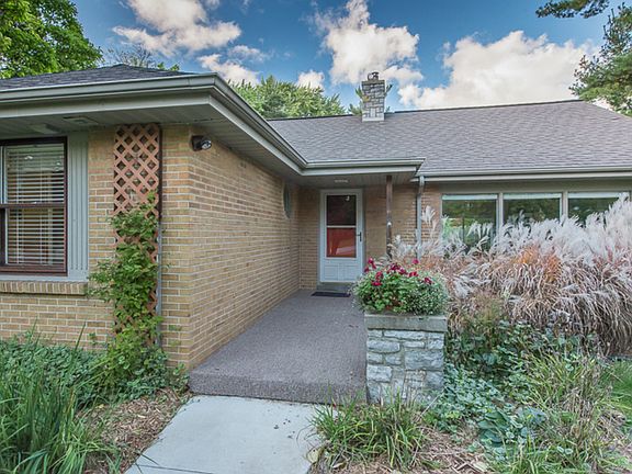 The welcoming front entry is enhanced with a newer concrete walkway, a large planter and professional landscaping.