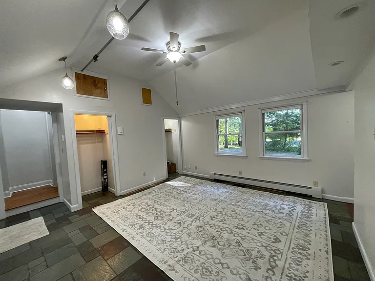 Large living room. Additional storage is available behind the wood access panels.