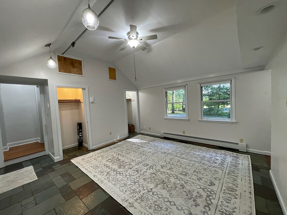 Large living room. Additional storage is available behind the wood access panels.