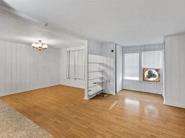 This is the front room or living room area (center right).
Suggestion: Large enough for a sofa, chair, & rocking chair. OR a sofa & love seat.
The area to the left, is the formal dining room area.
Suggestion: Large enough for a dinning table & china c