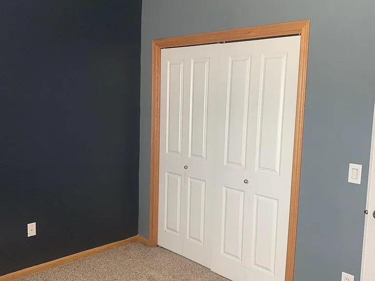 Bedroom closet and ledge w/ outlet.