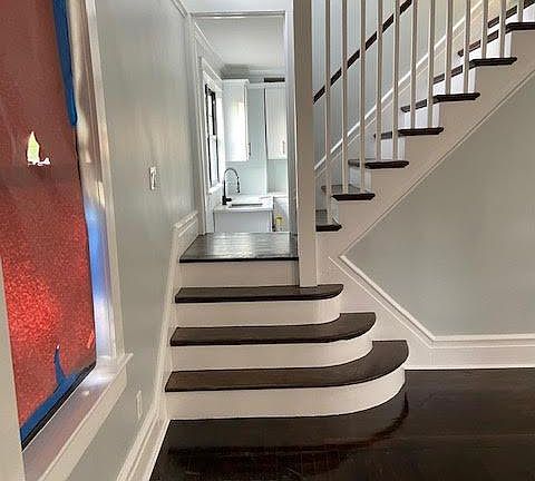 Living room staircase that is also open into the kitchen