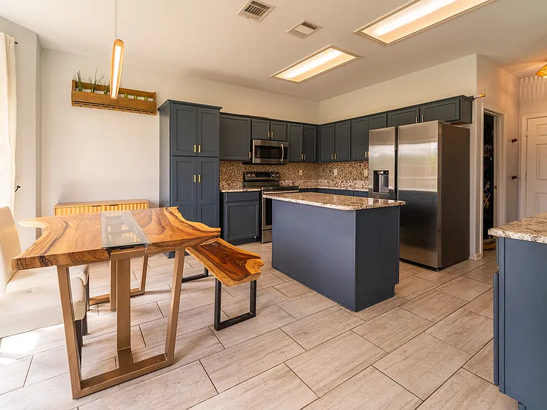 Chef's Kitchen: The heart of the home shines with gorgeous updated granite countertops, a functional kitchen island, and fresh paint throughout the entire lower level.