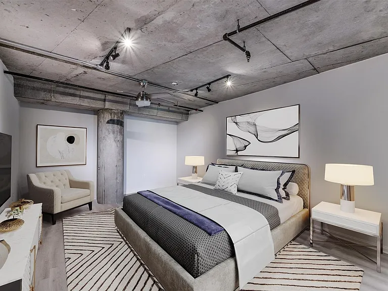 Exposed concrete ceiling and structural beams with track lighting