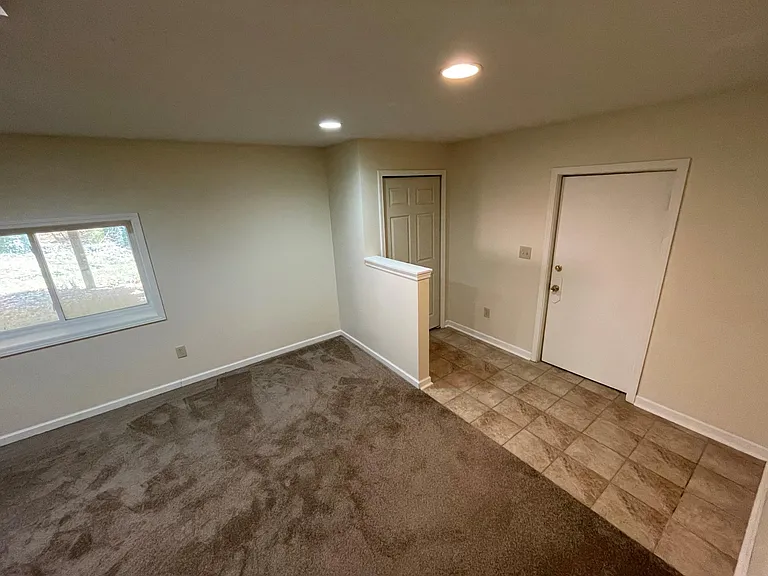 Lower level living room, garage access & walkout basement