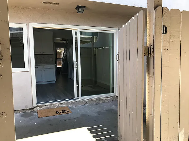 Back patio (touches unit and covered parking space)