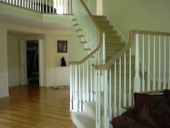 Entry stairwell with hardwood hall to the left