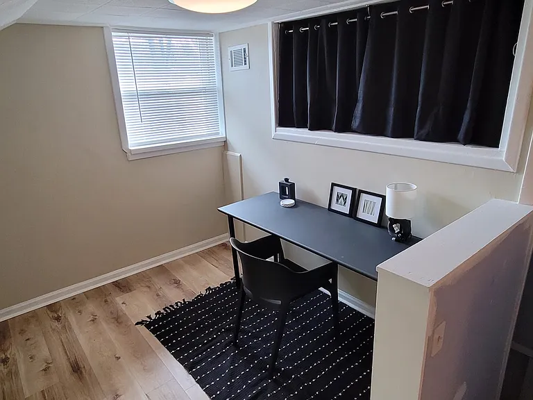 Second floor desk
area with curtained storage nook above desk.
