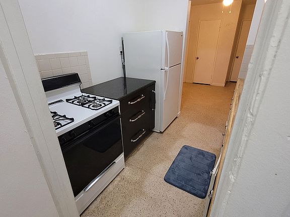 Kitchen provides lots of cabinet space. The black marble cabinet has pull out, multilevel drawer for spices.
