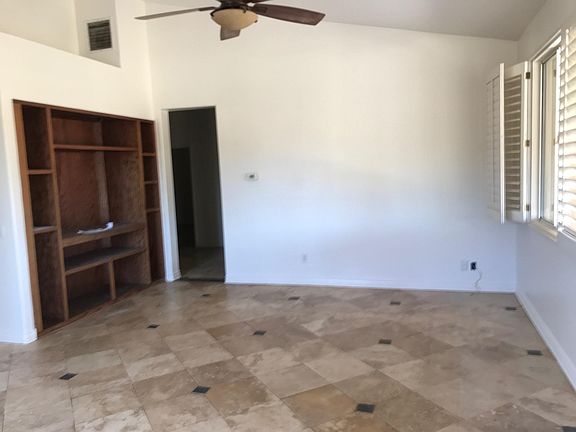 Family room to the left of kitchen. Built in unit for television. Hallway in photo leads to bedrooms.