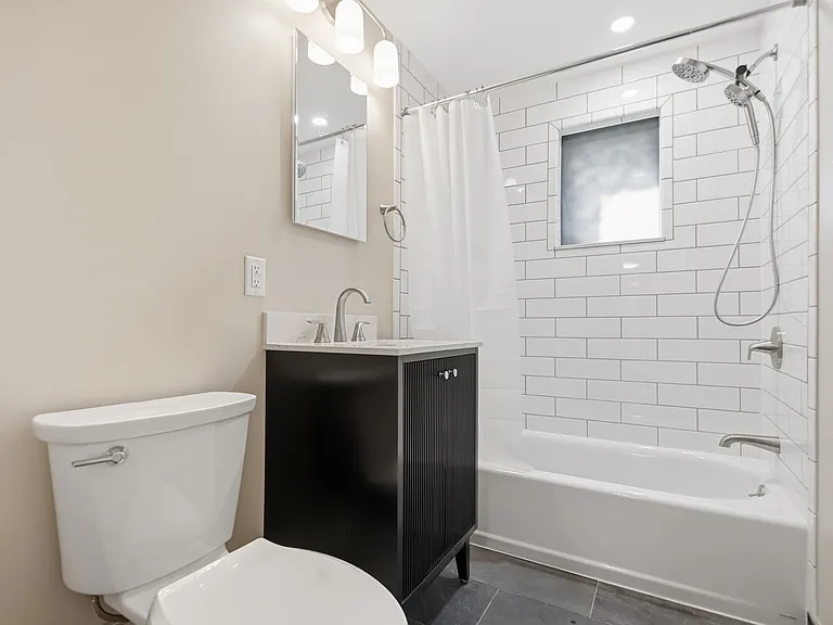 Full bathroom with privacy window (with laundry closet in hallway)