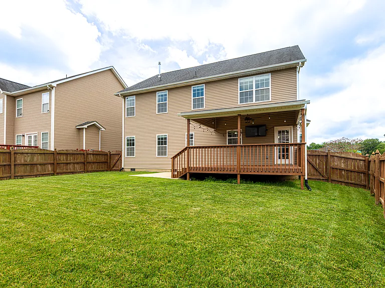 Relax in a fully fenced-in backyard designed for entertaining. The upper deck steps down to a dedicated concrete pad perfect for grilling. Unwind in the evening under the cozy string lighting or watch the game on the outdoor tv