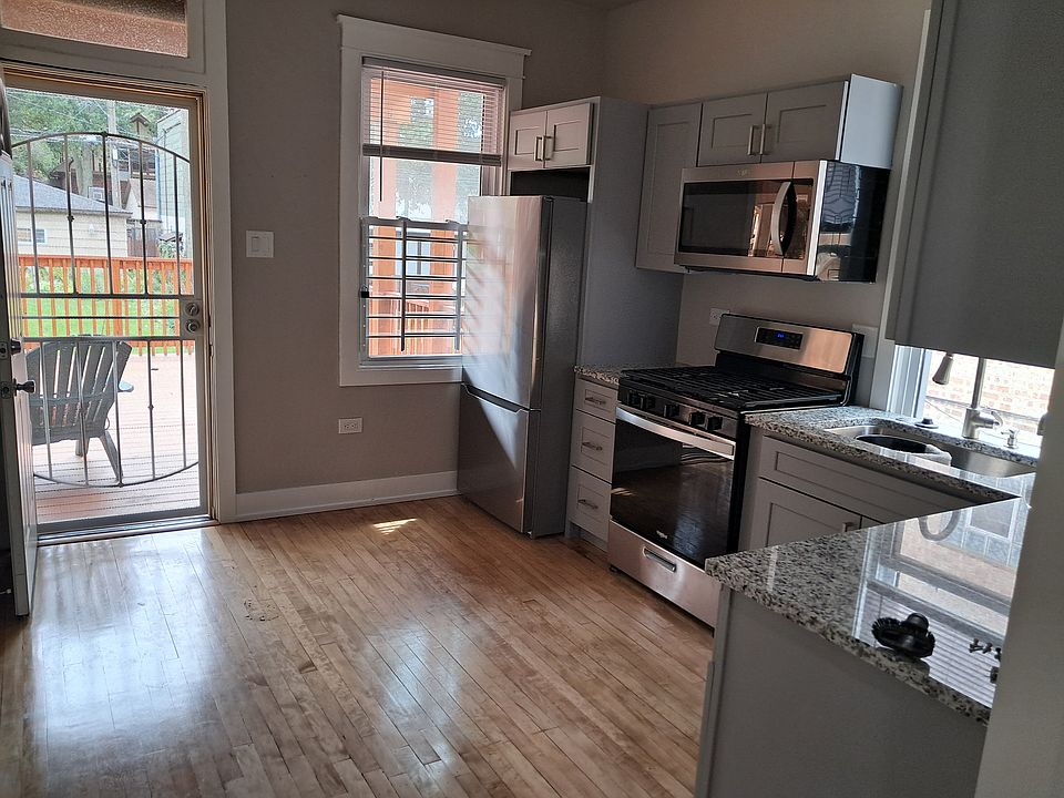Kitchen with back entrance leading to deck and backyard.