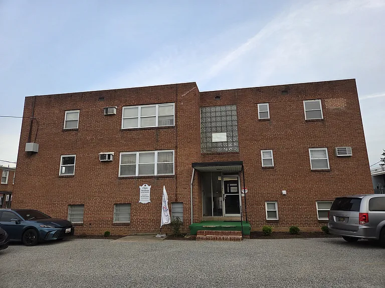 Front of building with parking spaces off street