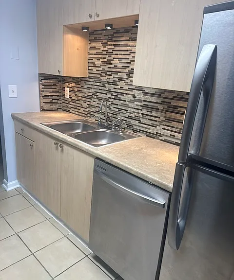Kitchen with stainless steel appliances and high end back splash