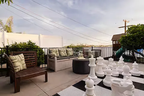 Spacious backyard packed with fun! Comfortable lounges, gather around the fire pit, cook on the pizza oven or BBQ, play the giant chess set, enjoy the playground, or watch movies on the large projector screen. Endless ways to play and unwind.
