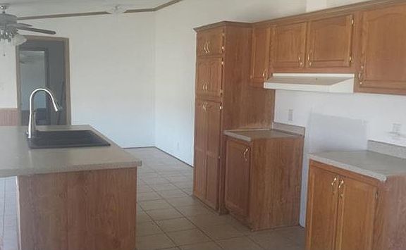Kitchen with tile floor and room for you dining table.