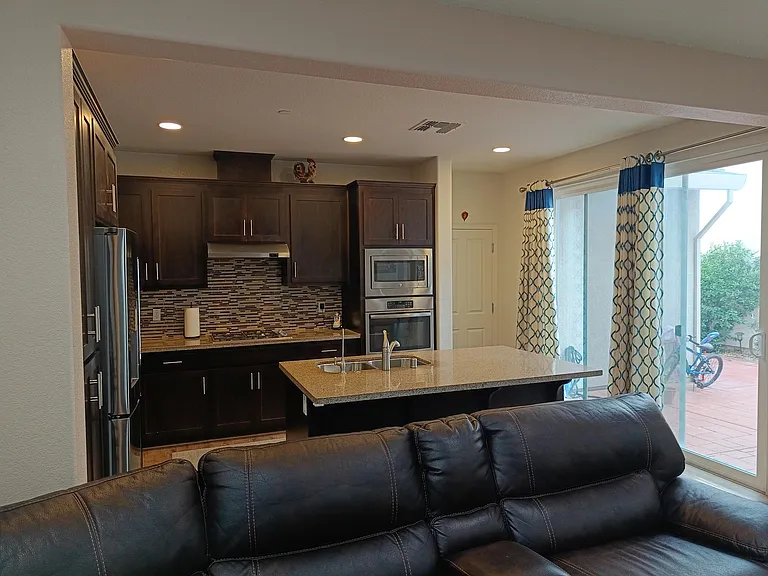 Embrace the warmth of natural light as it streams from the side yard into the living area and kitchen. An inviting view that bathes your home in sunlight, creating a vibrant and welcoming atmosphere. Experience the beauty of indoor-outdoor living. ____