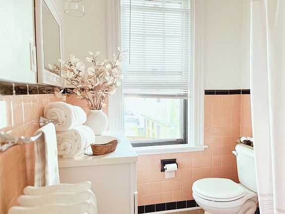 Vintage-inspired Bathroom: This bathroom combines classic tile with modern fixtures for a timeless look. The newly refinished cast iron soaking tub is perfect for unwinding after a long day.