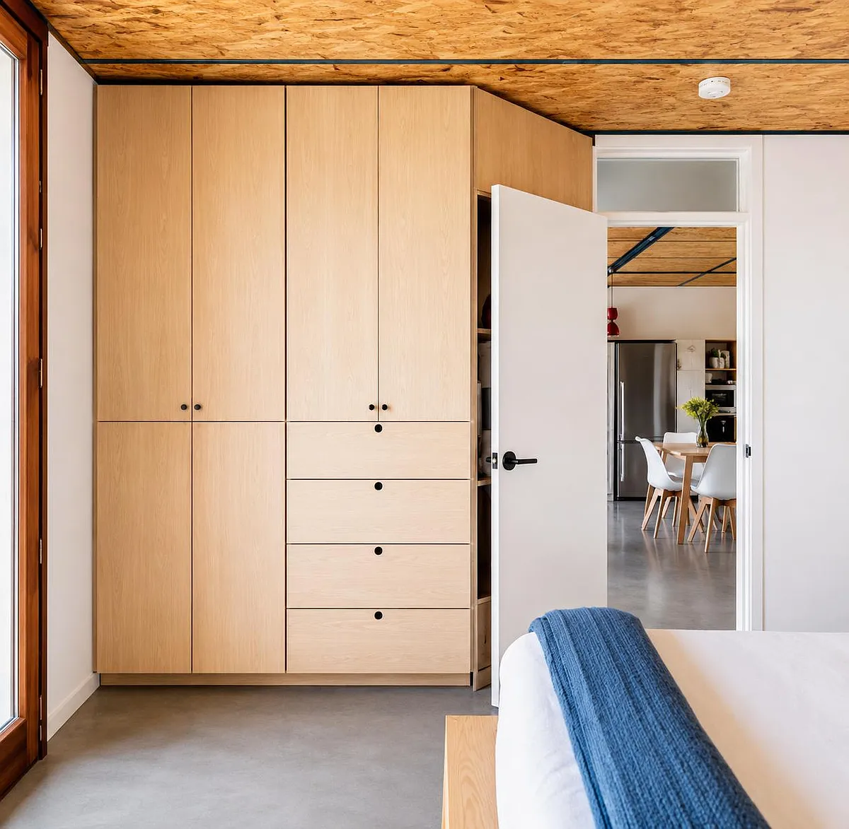 Bedroom features built-in wardrobe storage with drawers and easy access to adjacent dining/kitchen area. - Yucca Mesa Rd