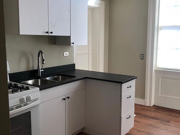 New kitchen cabinets and sink with touch-operated faucet.