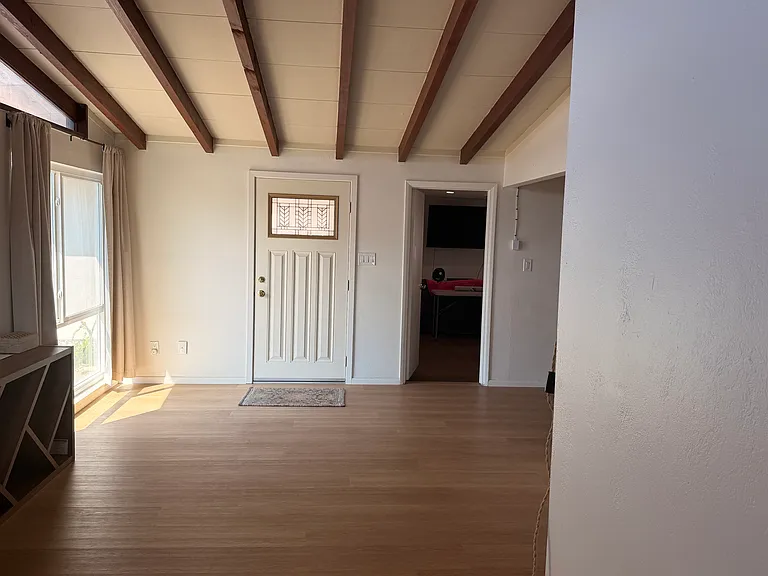Room where you enter through the front door. You can see the entryway to the large family room to the right of the front door entry..