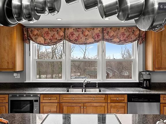 New kitchen with island, granite tops, limestone flooring.