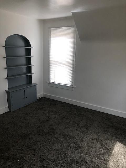 Large living room with built in bookshelf and storage