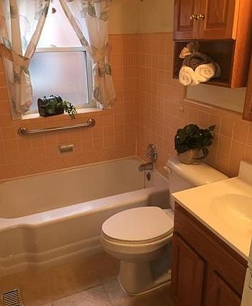 Bathroom offers updated vanity and ceramic tile flooring.