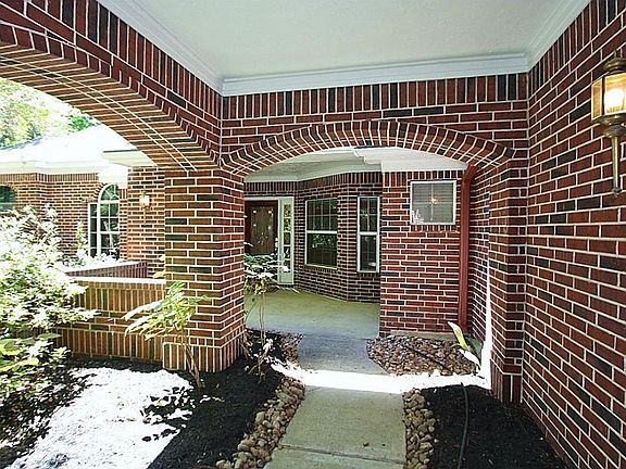 The all brick home greets you with this covered arch in the entry.