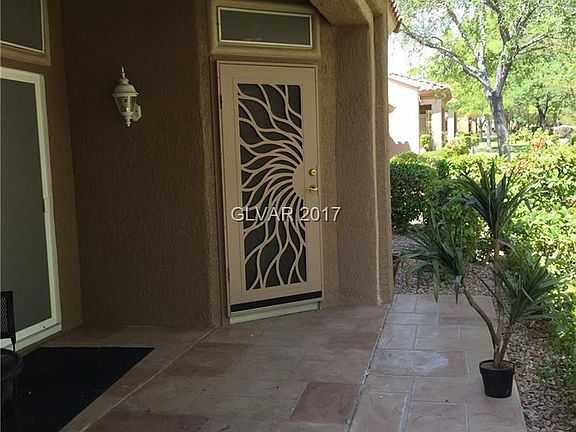 CUSTOM SECURITY DOOR GIVES ACCESS TO FAMILY ROOM.  BACK PATIO IS EXTENDED WITH DECORATIVE CONCRETE.