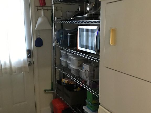 Back door with washer and dryer in separate utility room.