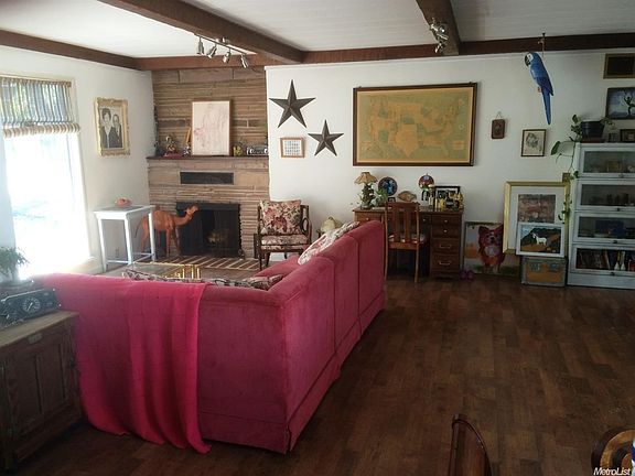 Large living room with fireplace and beamed ceiling.