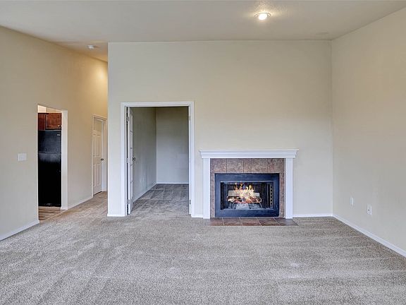 An open floorplan seamlessly flows into the dining area and kitchen.>