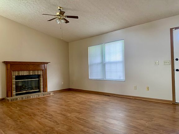 Great room with vaulted ceiling and fan