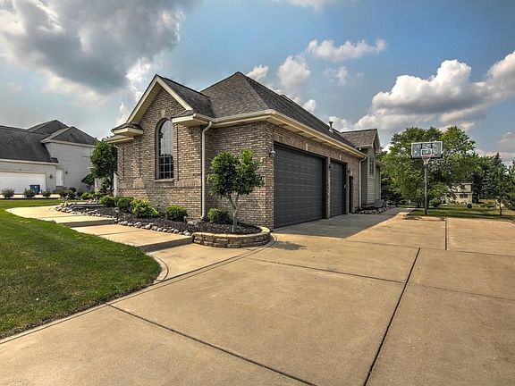 HUGE 3 CAR SIDE LOAD HEATED GARAGE WITH SERVICE DOOR