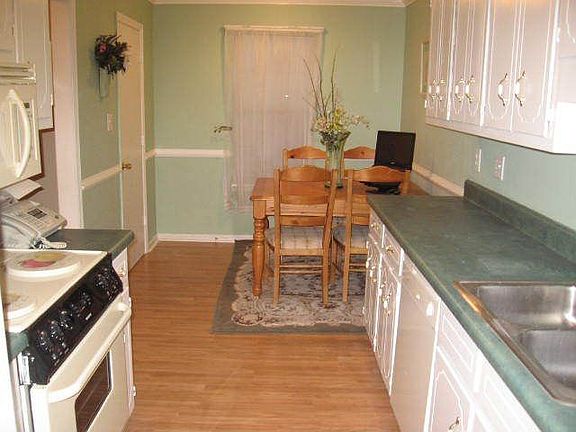 Eat-In Kitchen w/ crown molding and wood floors; all appliances conveyed