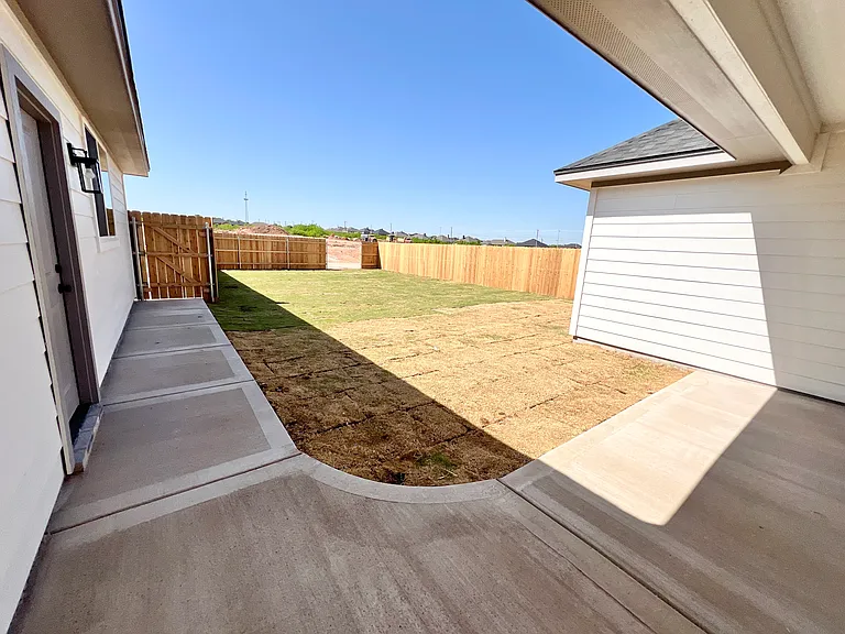 Backyard is fully fenced and landscaped with a sprinkler system and sod that has just been laid