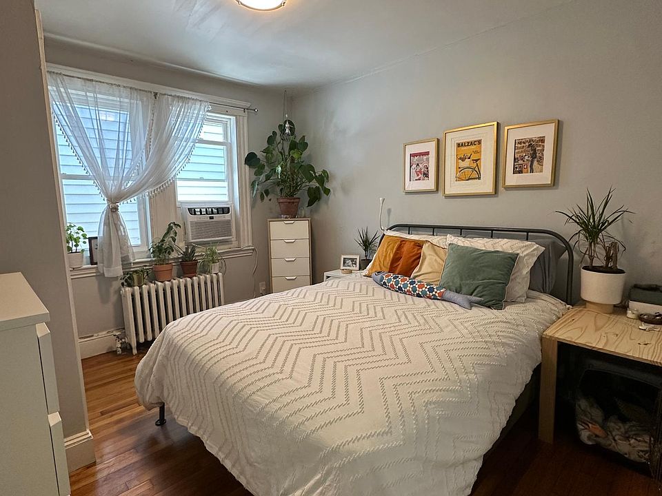 Bedroom with large closet, windows toward private back alley and window AC unit included