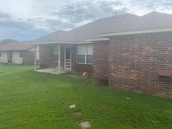 Back of house with covered porch