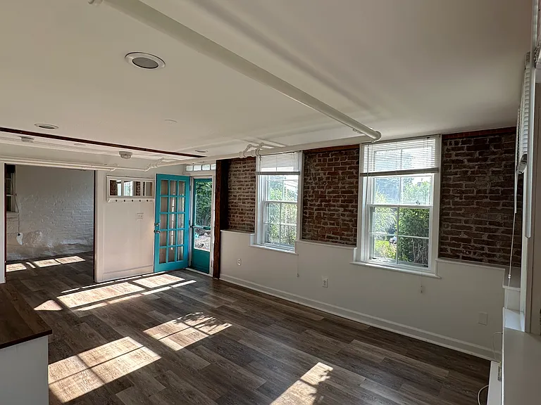 Living room facing front door and bedroom.