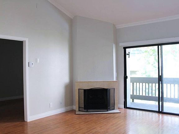 Cozy fireplace in living room. (Also in photo: Door to bedroom and 2nd balcony)