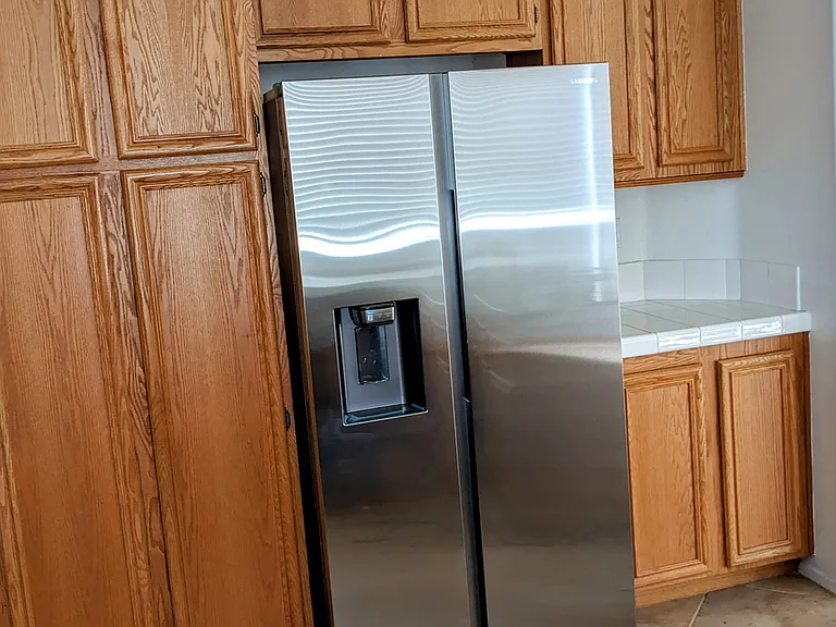 This picture shows the brand new stainless steel refrigerator, this appliance comes with the house.